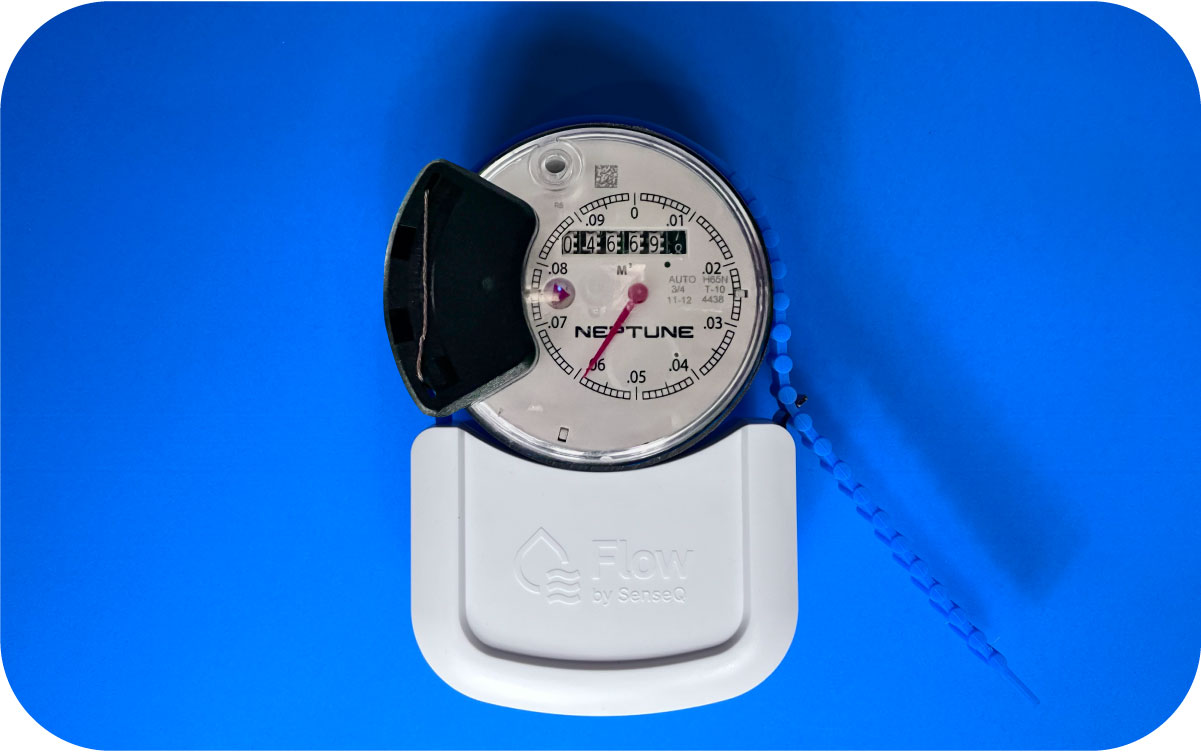 Person installing SenseQ sensor on water meter